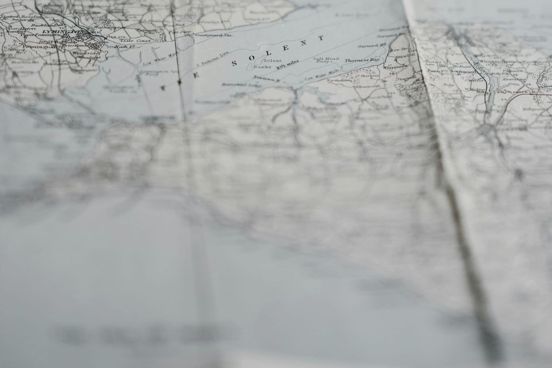 A close-up of a folded paper map, mostly out of focus.