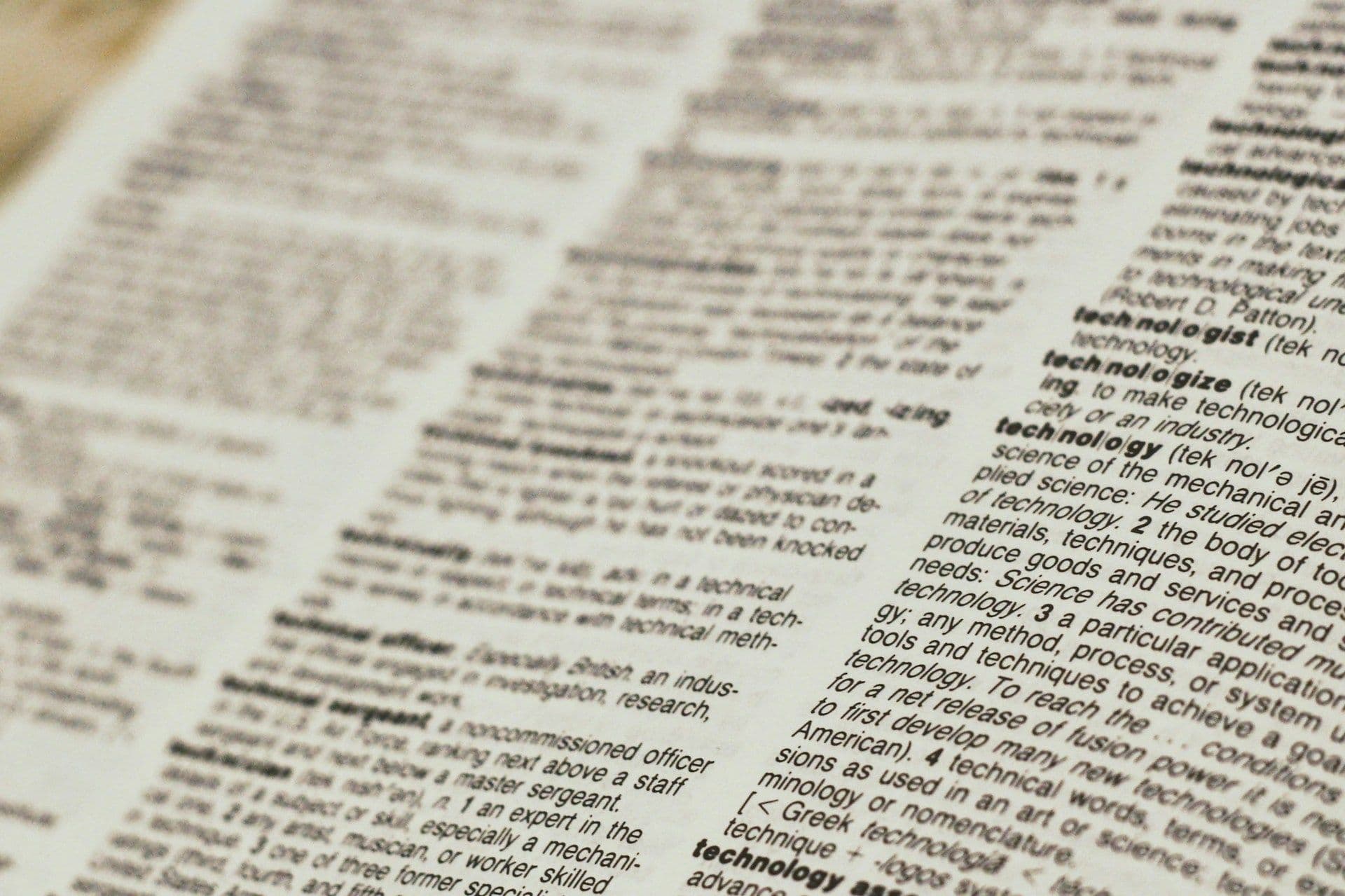 A dictionary is open to a page that says technology