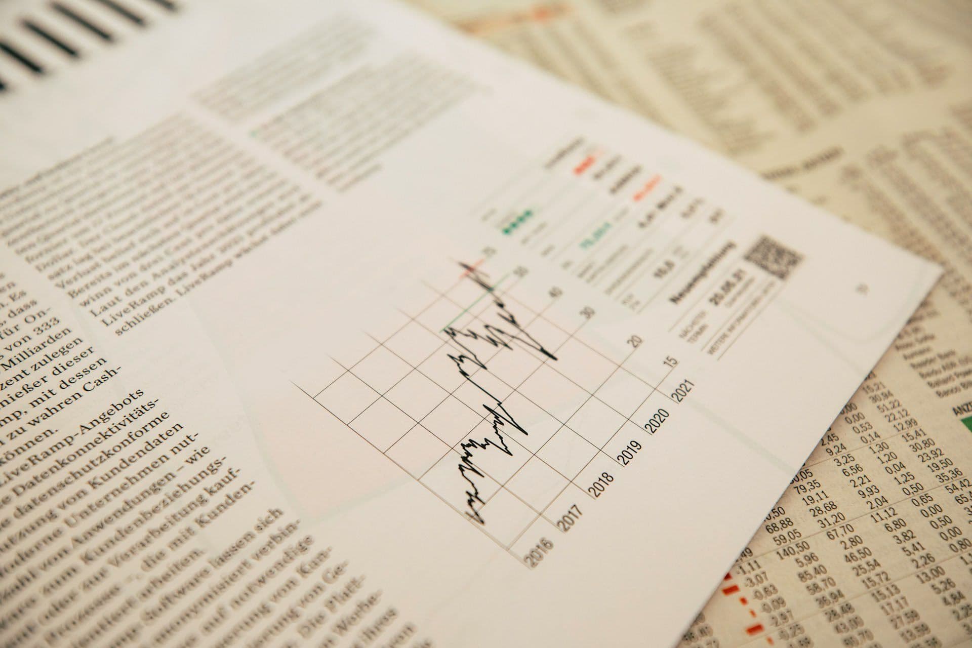 A graph is sitting on top of a newspaper.
